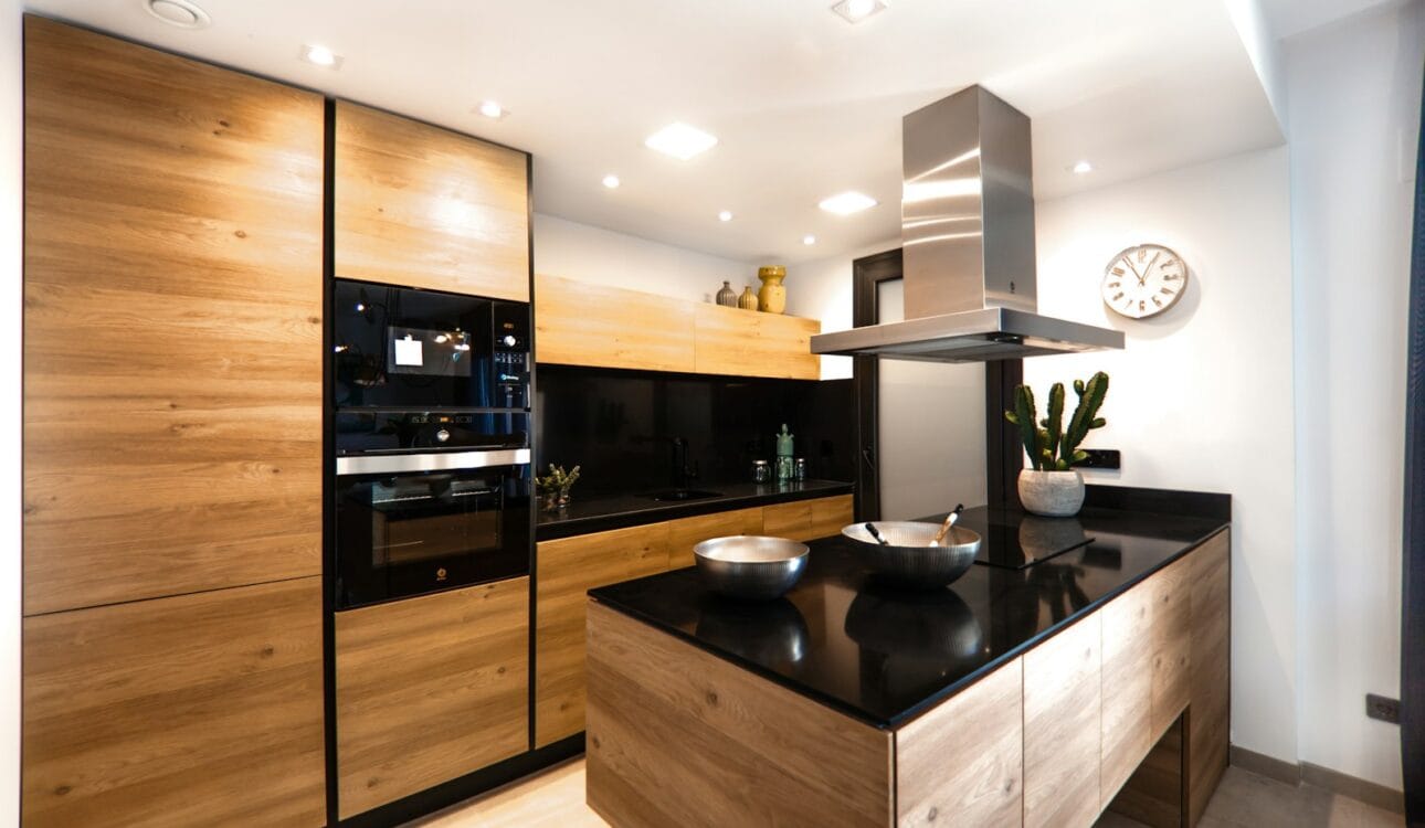 Large modern kitchen with marble worktop and smooth cabinet fronts