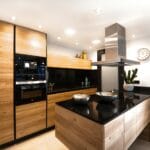 Large modern kitchen with marble worktop and smooth cabinet fronts