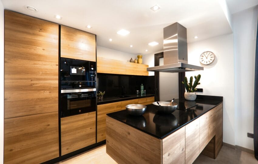 Large modern kitchen with marble worktop and smooth cabinet fronts